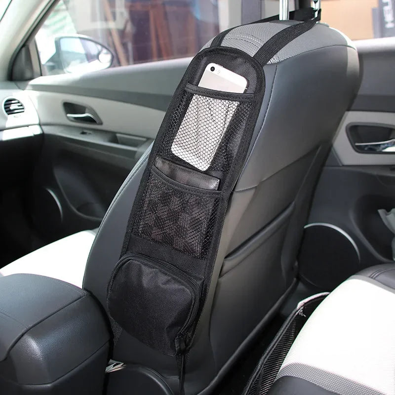 Car seat organizer with mesh pocket and phone holder attached to a car seat.